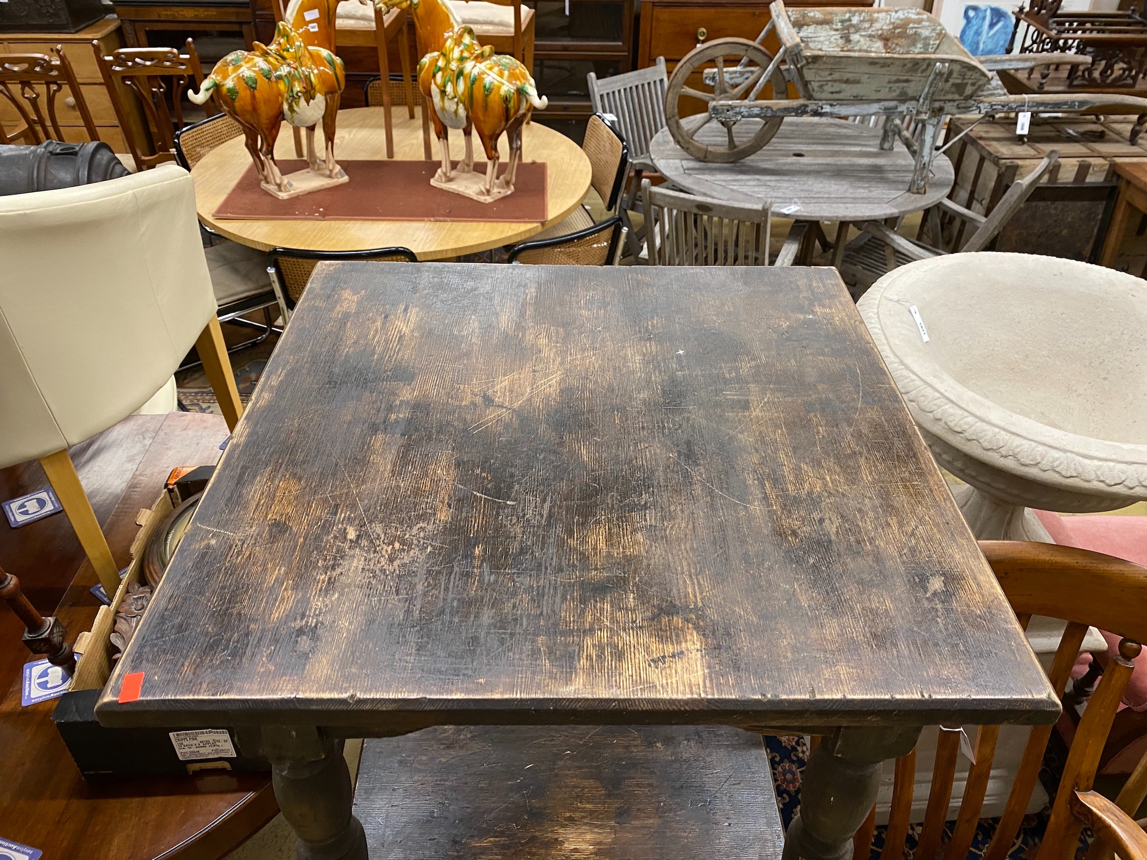 A pair of square stained pine tavern tables, width 65cm, height 75cm